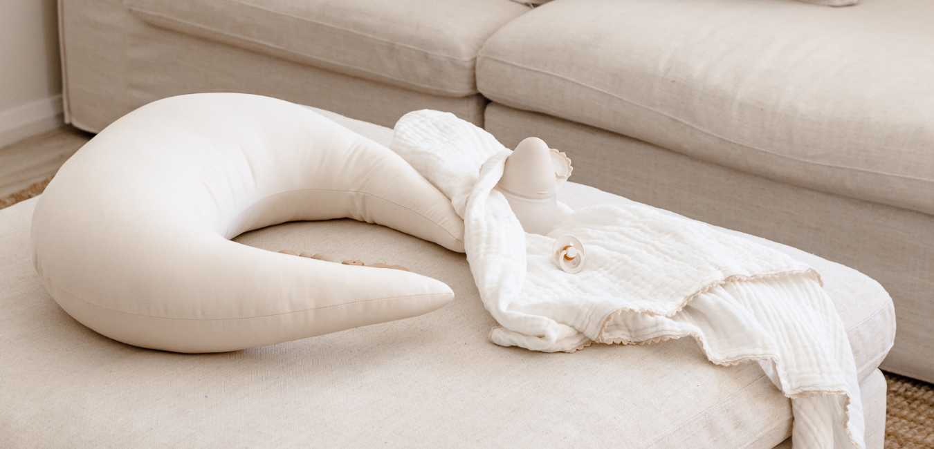 A white pillow on top of a couch in a living room.