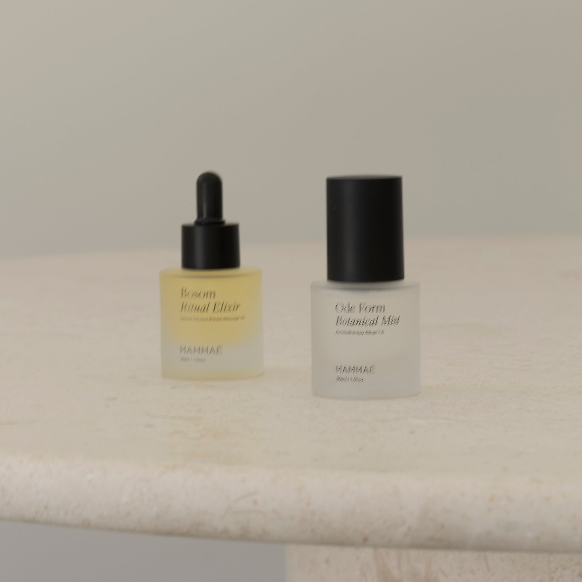 Two bottles of Mammae EXCLUSIVE mini ritual duo sitting on a marble table.