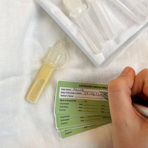 A person is holding a card with a sample of Haakaa Pre-sterilised Silicone Colostrum Collector | 6pk on it.