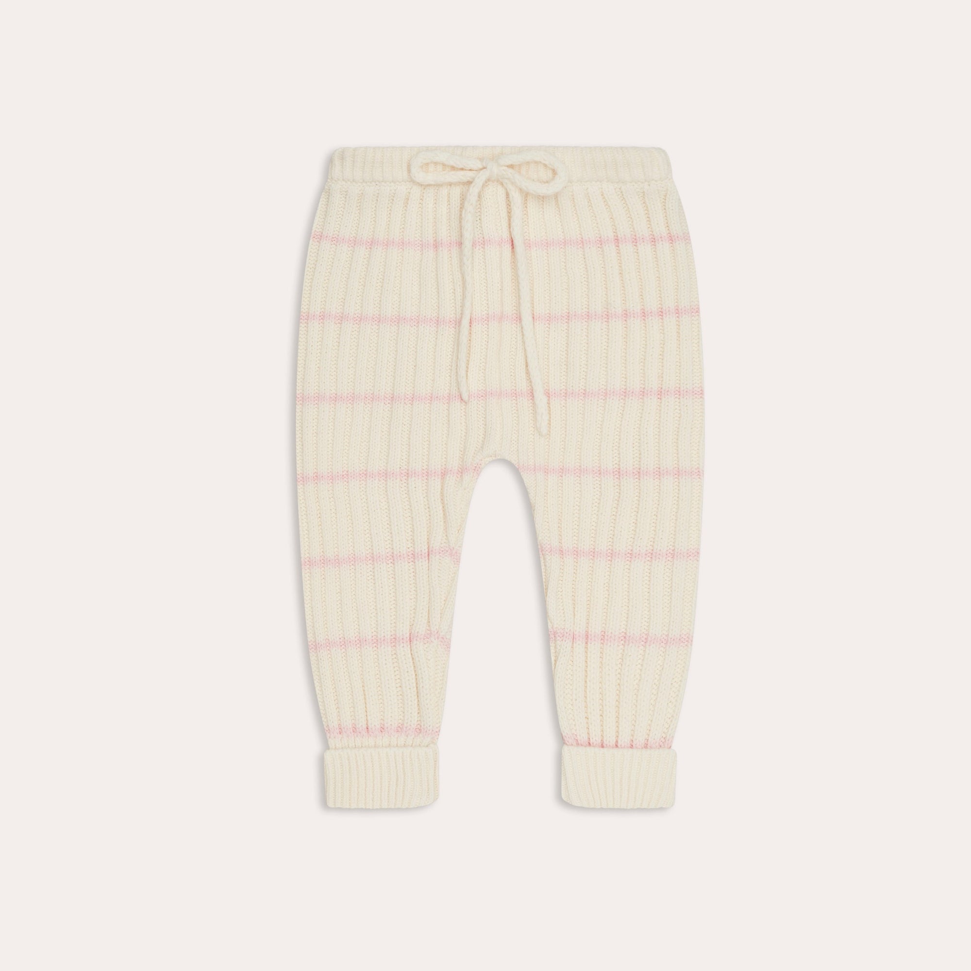 These illoura knit joey pants | pink stripe from Illoura the Label are made from organic cotton knit and have an elasticated waist, perfect for a baby. They come in a cute white and pink striped design.