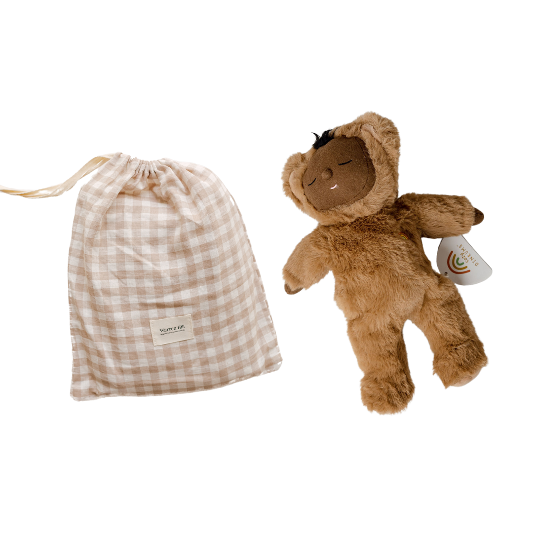 A brown teddy bear with a cozy things gift set from biglittlethings next to it, providing comfort to a baby.