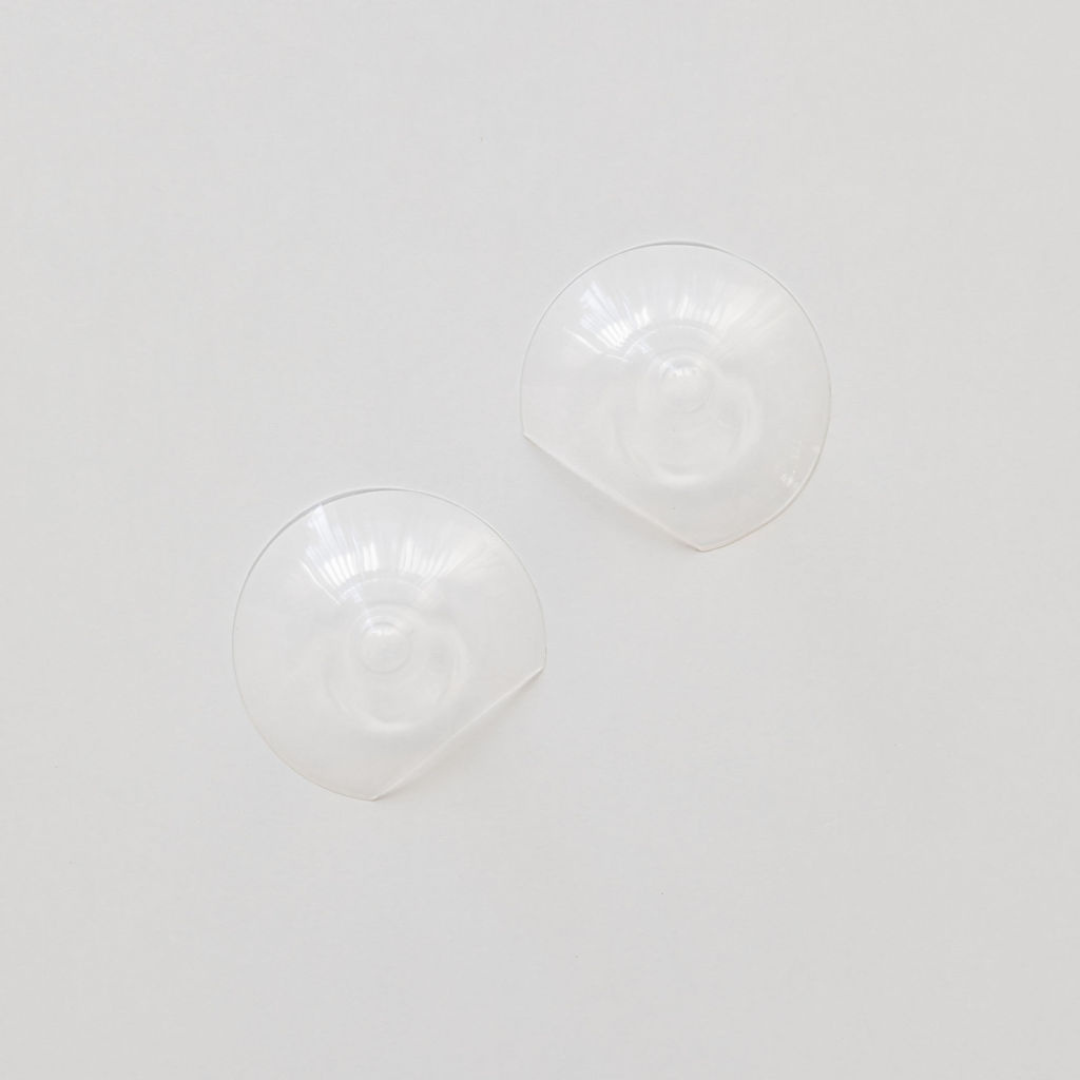 A pair of Haakaa Silicone Nipple Shields on a white surface.