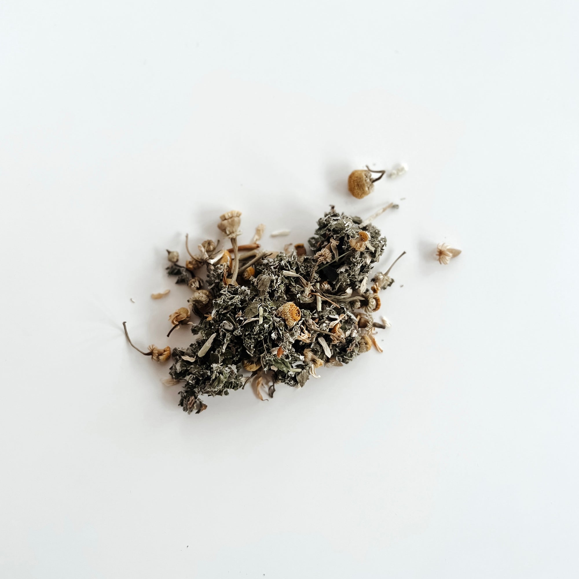 A pile of Clē Naturals' Organic Raspberry Leaf Tea on a plain white background.