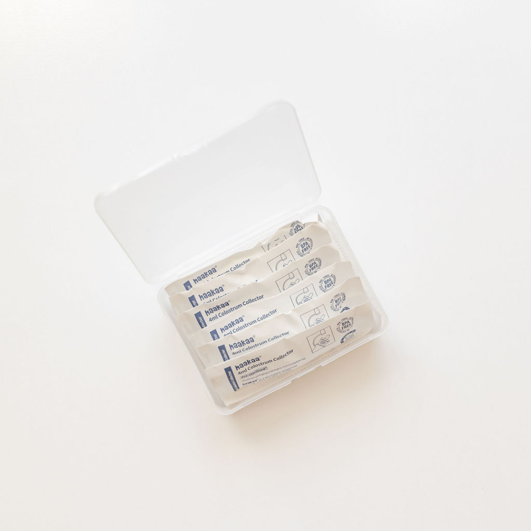 A Haakaa clear plastic box with a set of colostrum collectors in it.