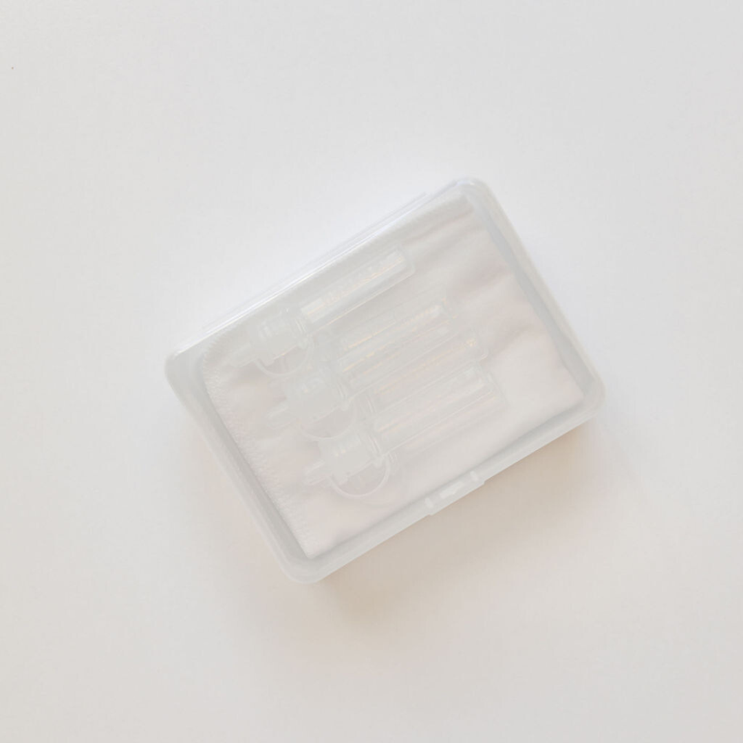 A small Haakaa Pre-sterilised Silicone Colostrum Collector | 6pk container with a lid on it.