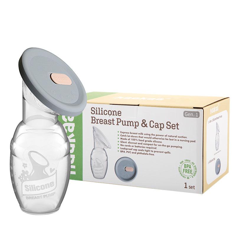 A small Haakaa Silicone Breast Pump & Silicone Cap Gen 1 bottle next to its box on a white surface.