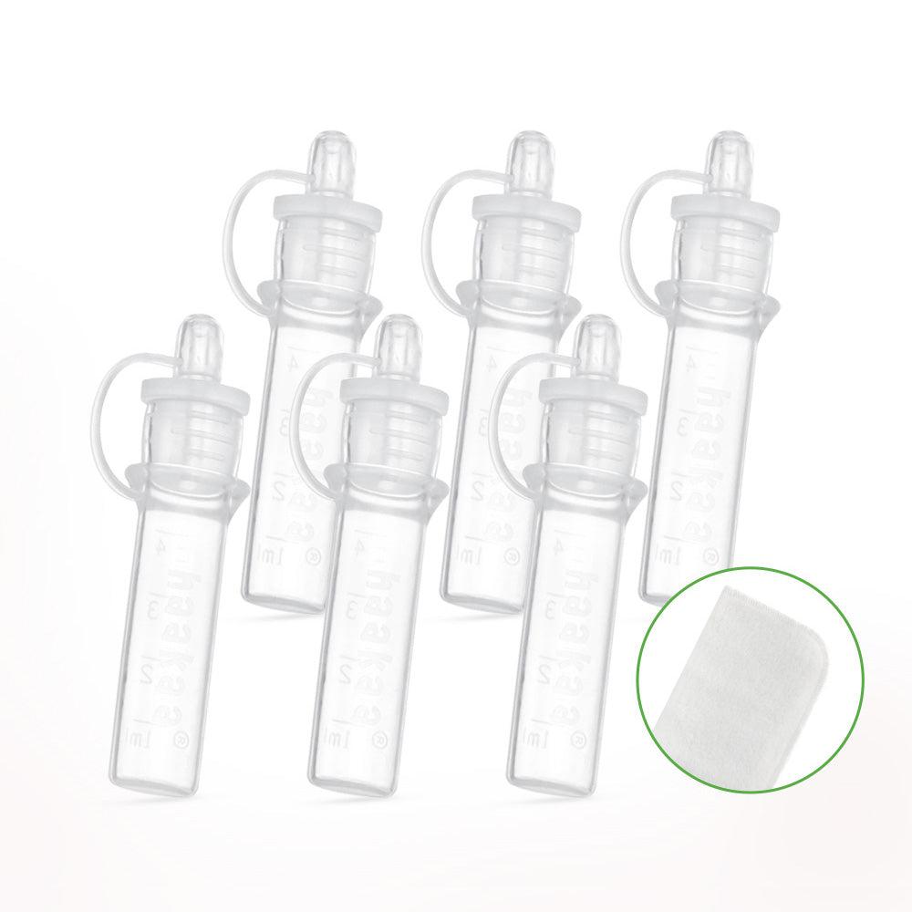 A set of Haakaa Pre-sterilised Silicone Colostrum Collector | 6pk bottles with a green lid.