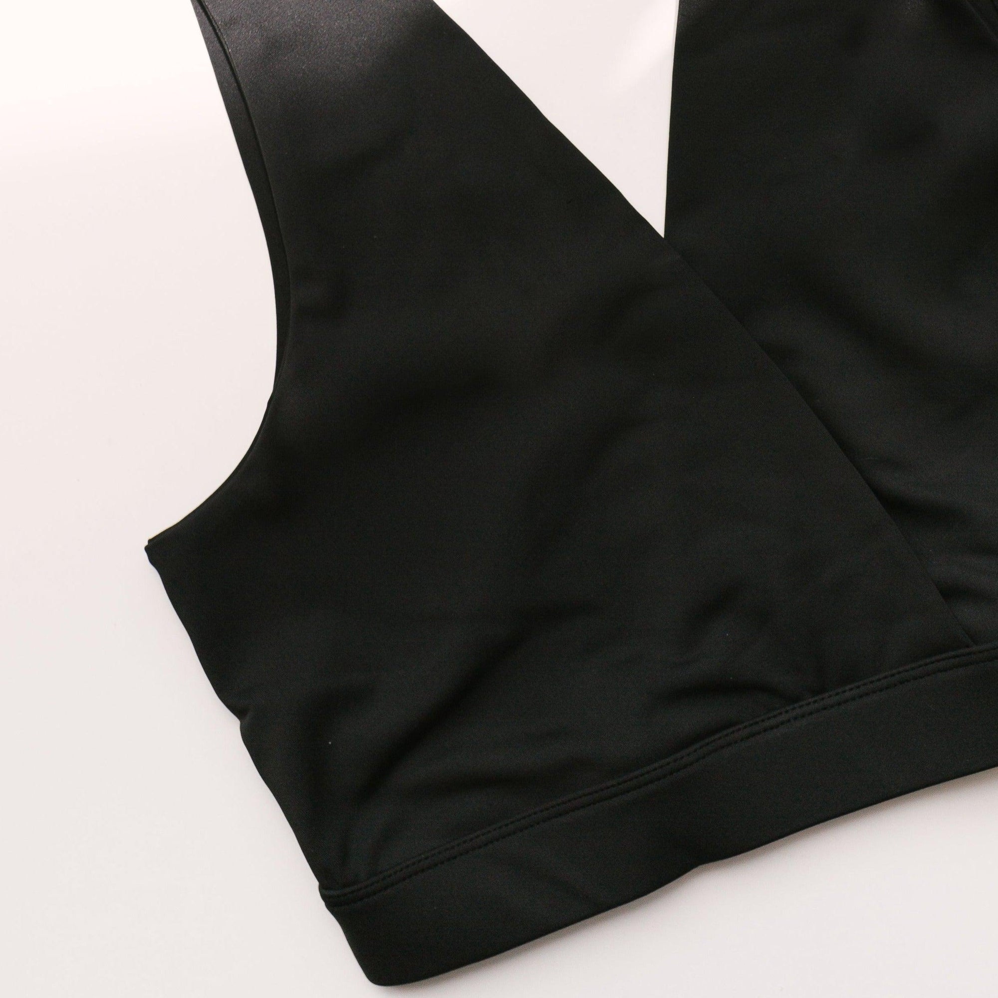 A black Postpartum Bralette on a white surface, designed for breastfeeding mothers.