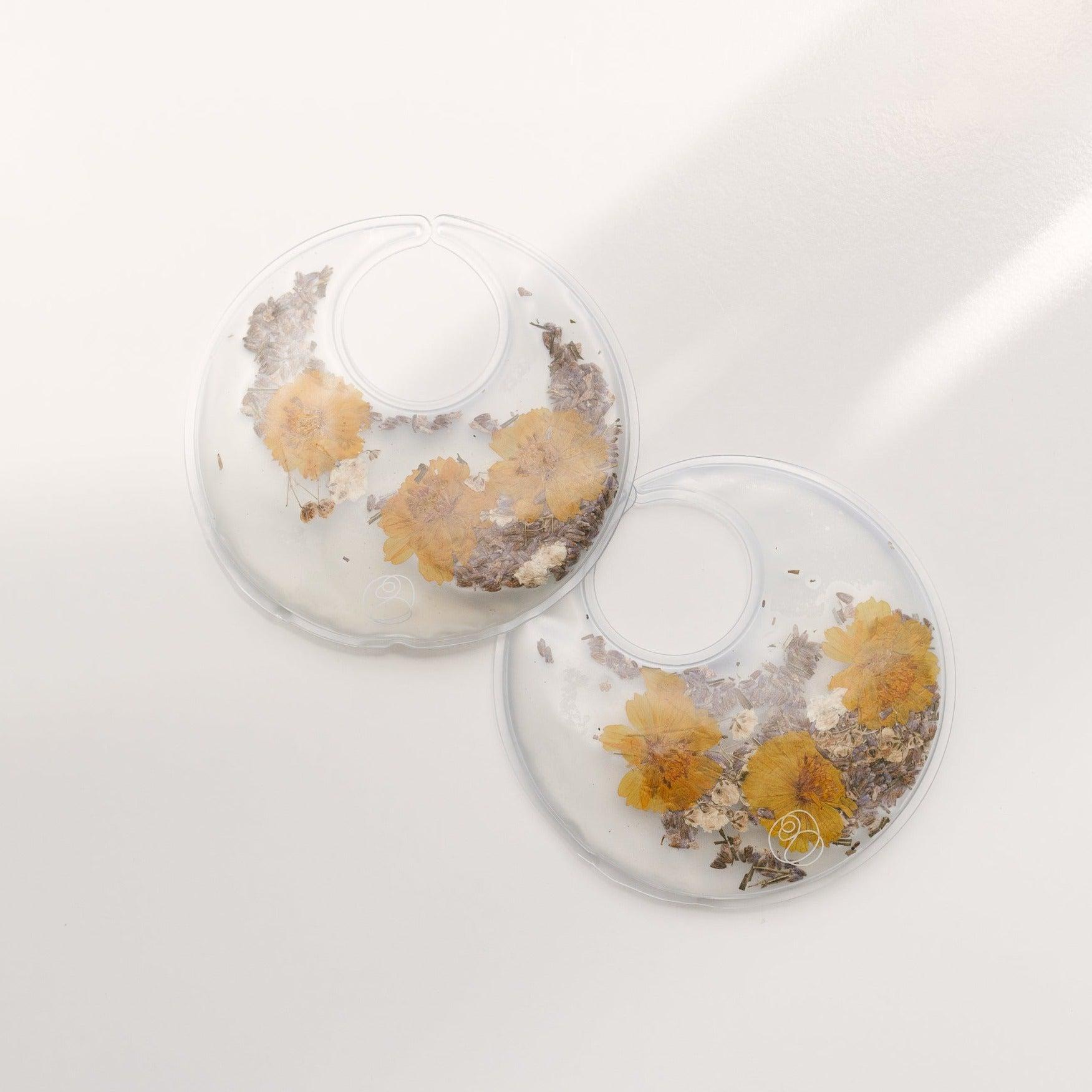 A pair of Bare Mum Breast Care Kit earrings for the mother's recovery after giving birth.