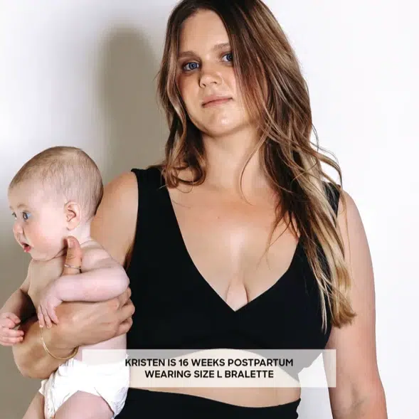 An image of a mother wearing a Postpartum Bralette by Bare Mum holding a baby.