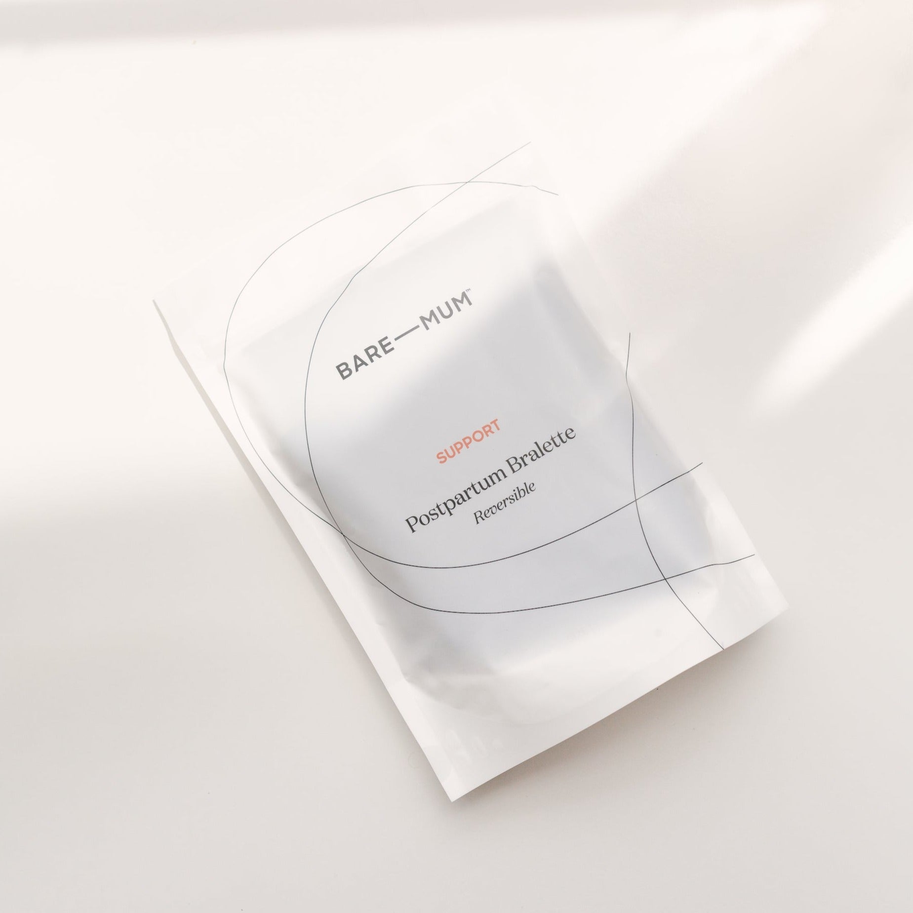 A postpartum Bare Mum Breast Care Kit packet sitting on top of a white surface.