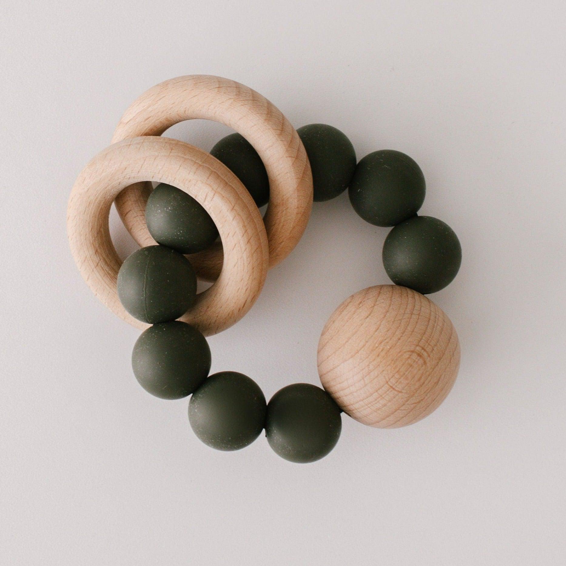 Two untreated wood rings move freely around the circle of 20mm BPA free silicone beads creating a soft rattle when baby shakes. All finished off with massive 35mm untreated beech wood bead.