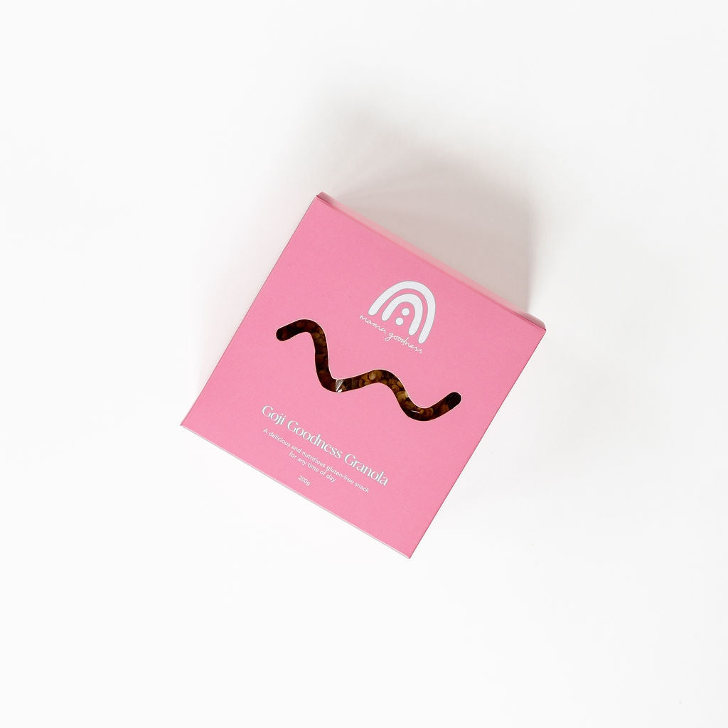 A pink box with a wavy line on it containing Mama Goodness goji goodness granola.