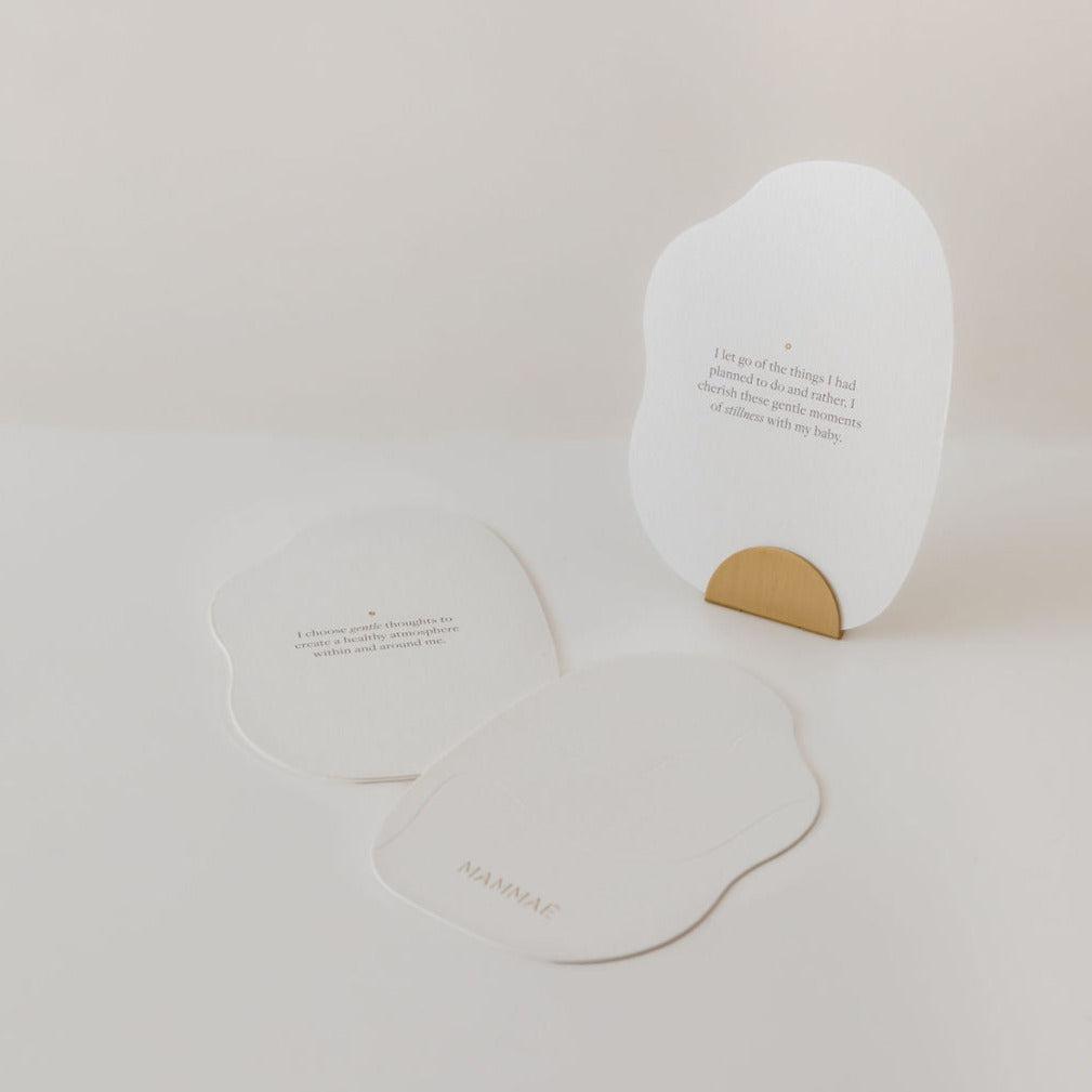 A Mammae bosom reflections card adorned with a delicate gold leaf, perfect for breast care during postpartum and pregnancy.