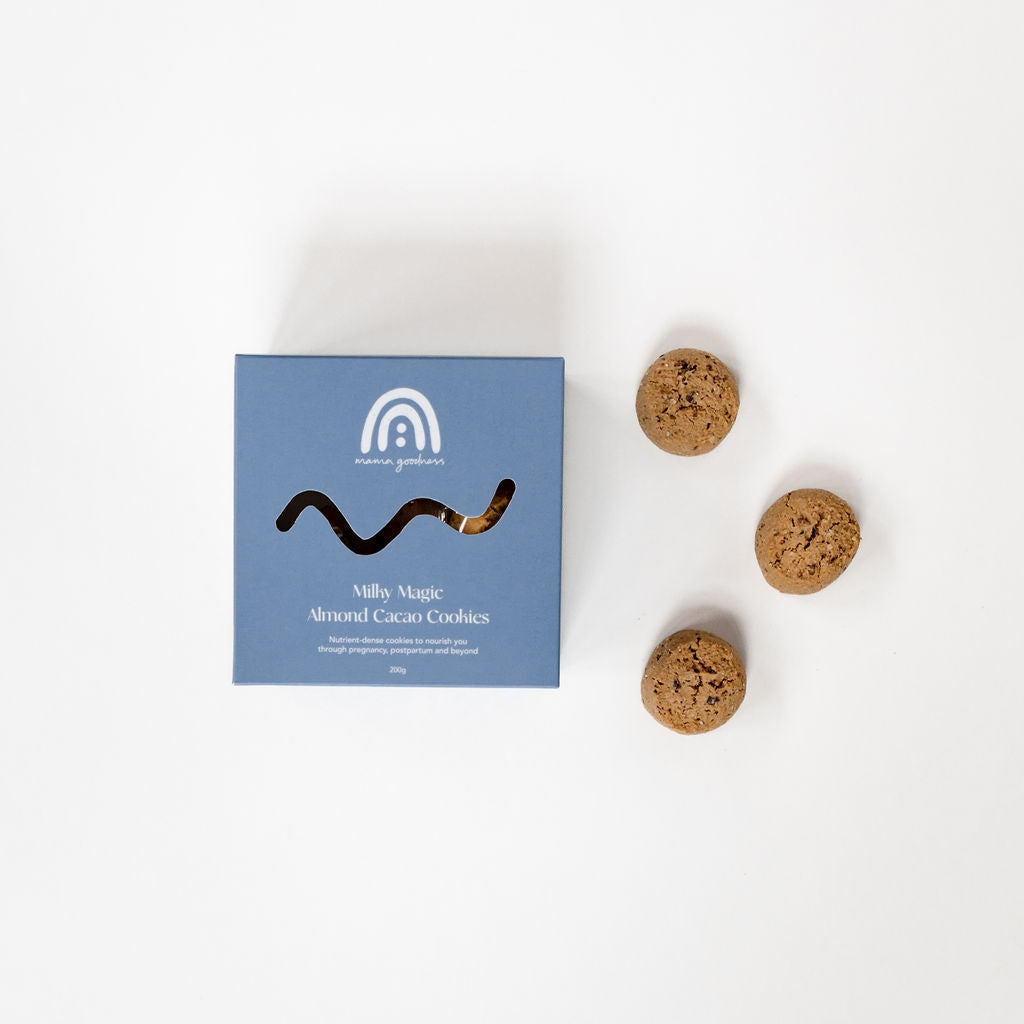 A box of Mama Goodness milky magic almond cacao cookies next to a blue box with a snake on it.