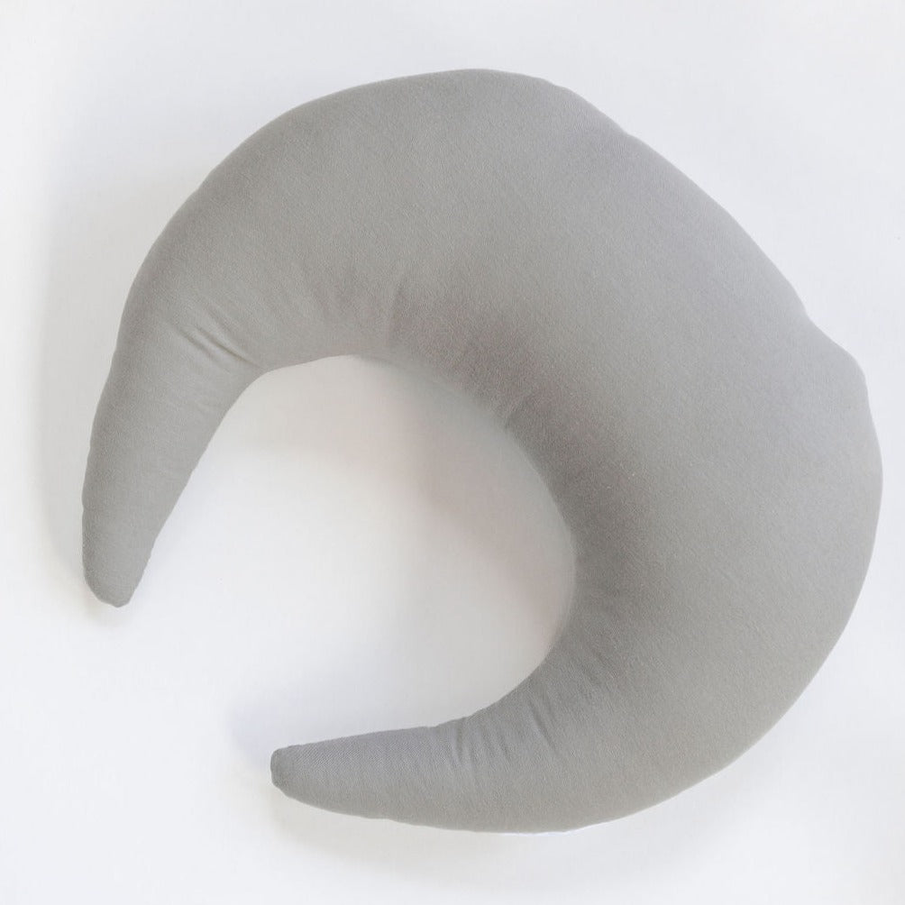A grey Snuggle Me Feeding & Support Pillow in the shade stone on a white surface.