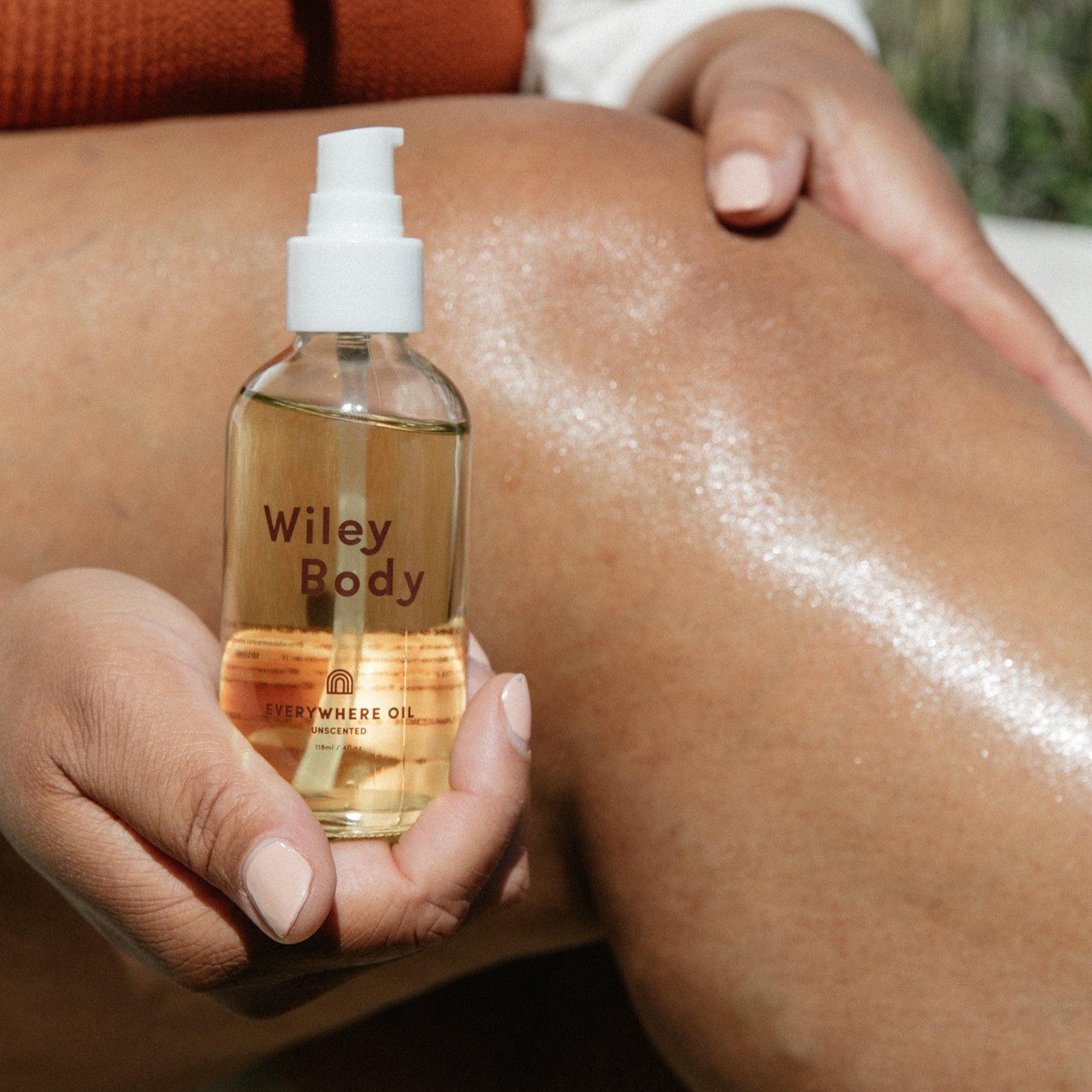 An organic aloe vera hand and body wash bundled with Wiley Body bundle, held by a woman.