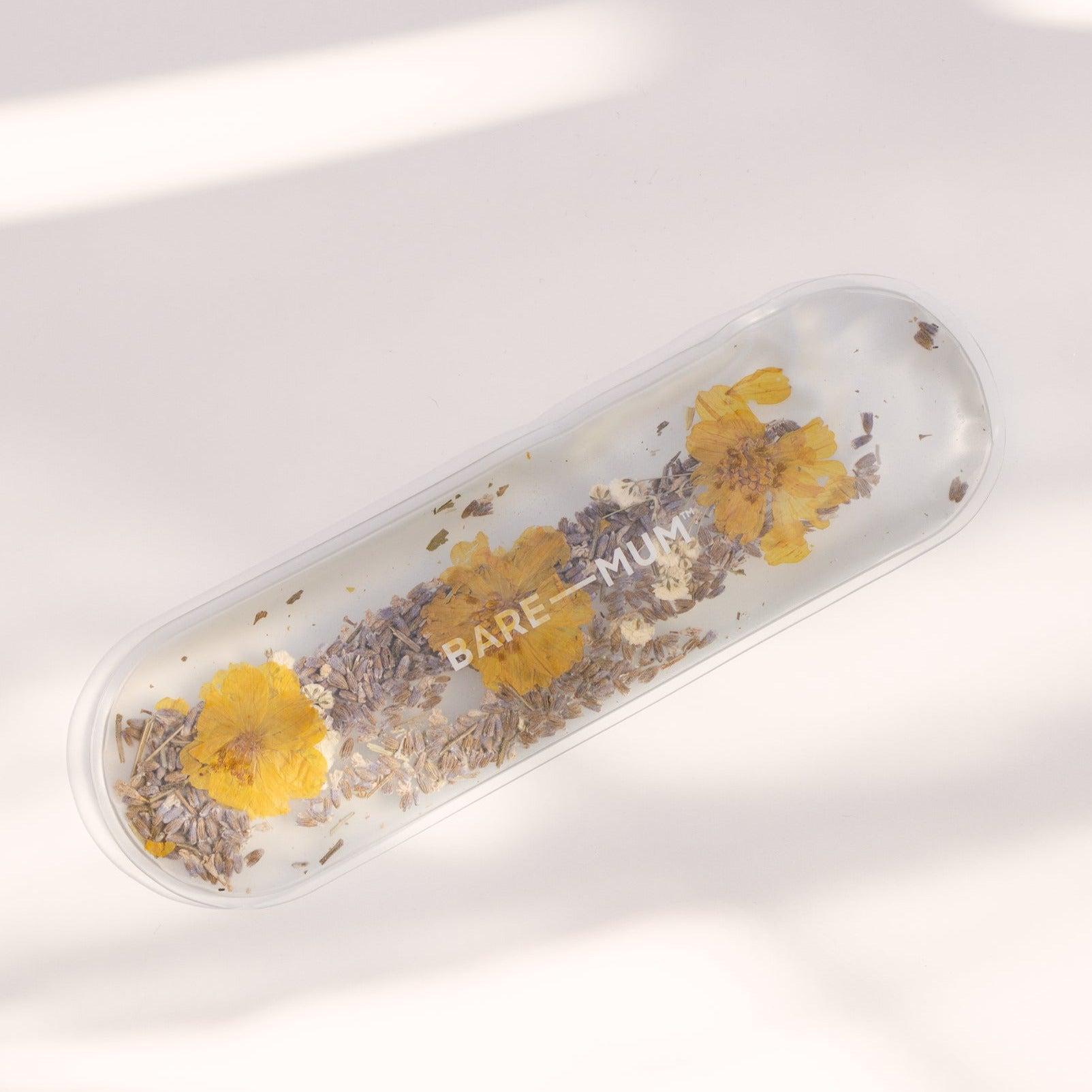  the Warm & Cool Insert filled with soothing dried flowers on a white surface, created for postpartum recovery by Bare Mum.