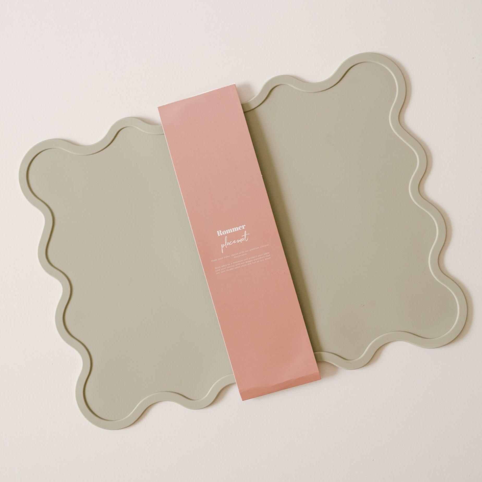 A Wiggly placemat in oyster colors on a white surface by Rommer.