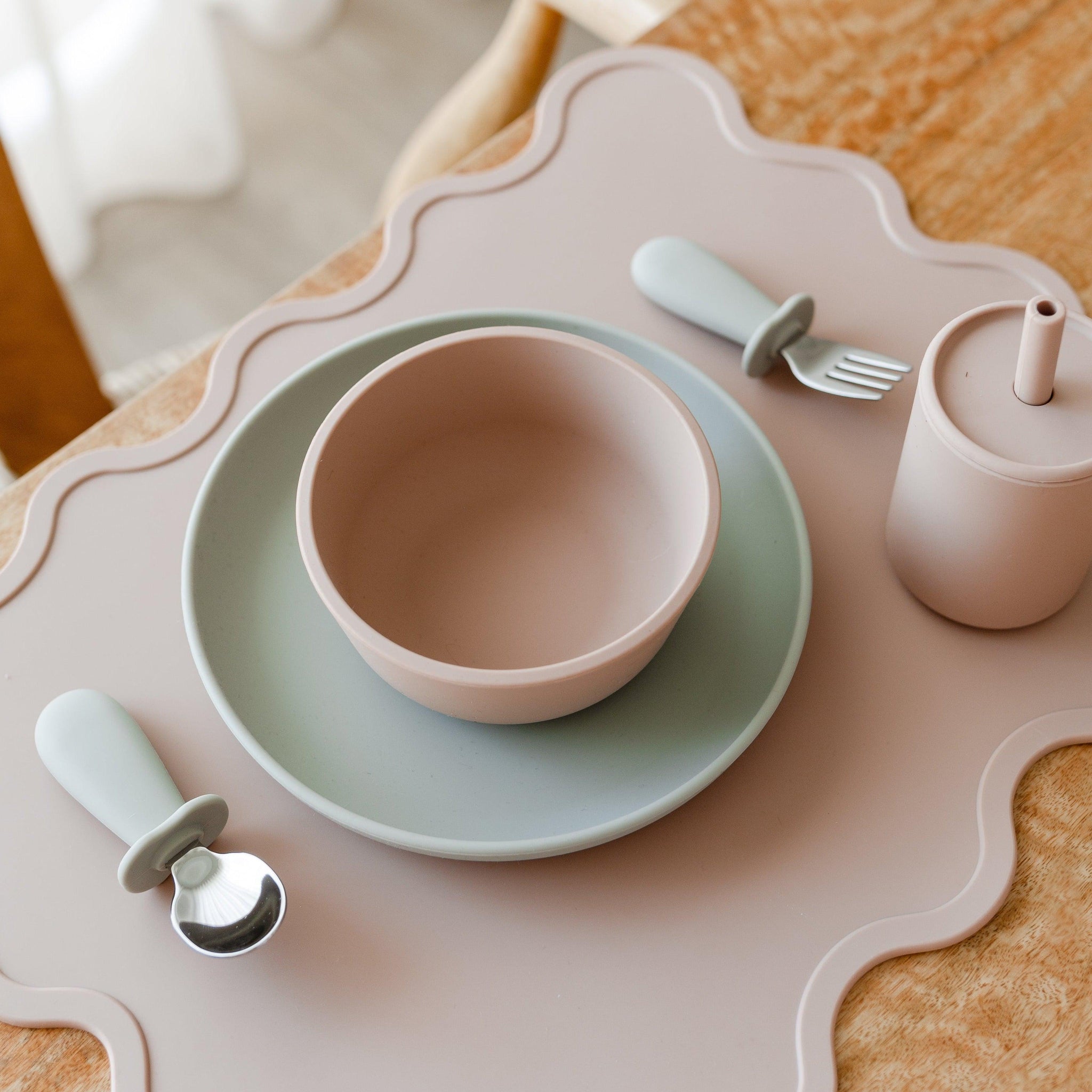 A table setting with a Wiggly Placemat | nude, Rommer fork and spoon.