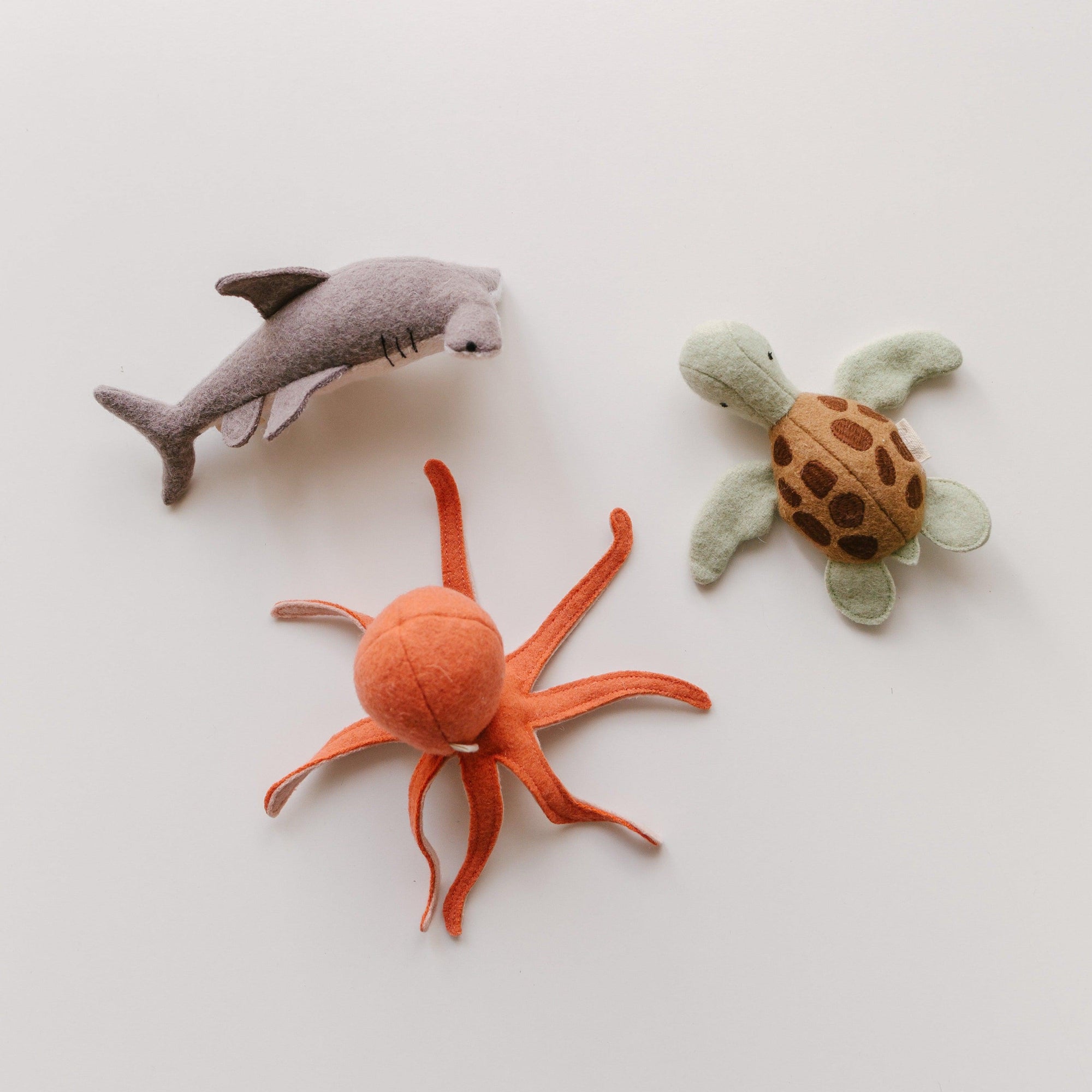 Looking for the perfect companions to embrace the enchanting world of marine wildlife? Look no further! Olli Ella's Holdie Folk - Marine Animals collection features a delightful assortment of octopus and shark stuffed animals, all ready to become your new friends.