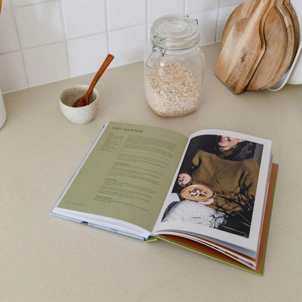 An open Life After Birth cookbook by Jessica Prescott & Vaughne Geary on a kitchen counter.