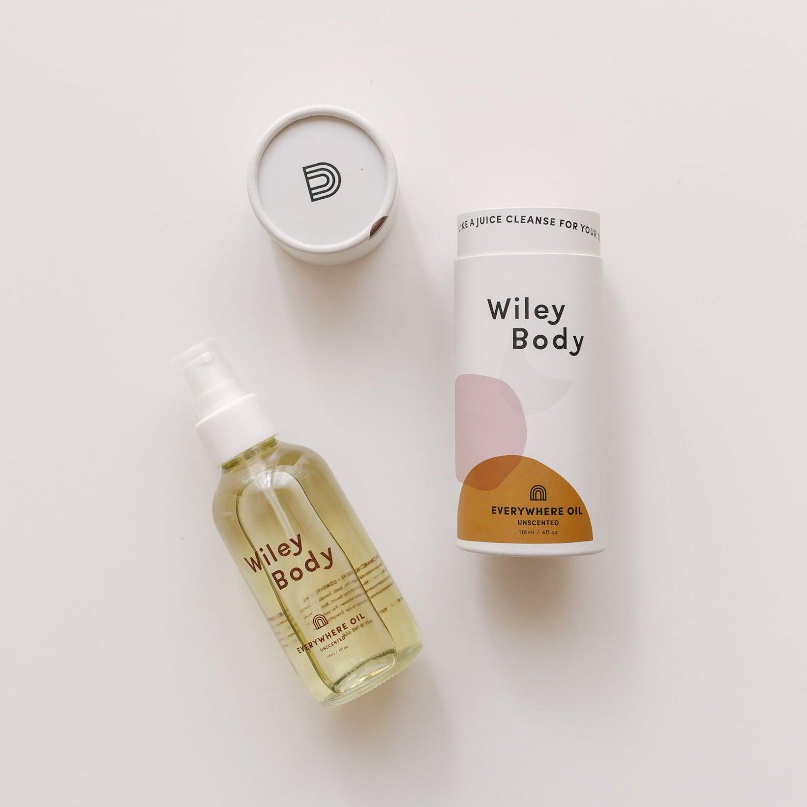 A nourishing Wiley Body bottle of everywhere oil and a moisturizing Wiley Body bottle of everywhere oil next to each other.