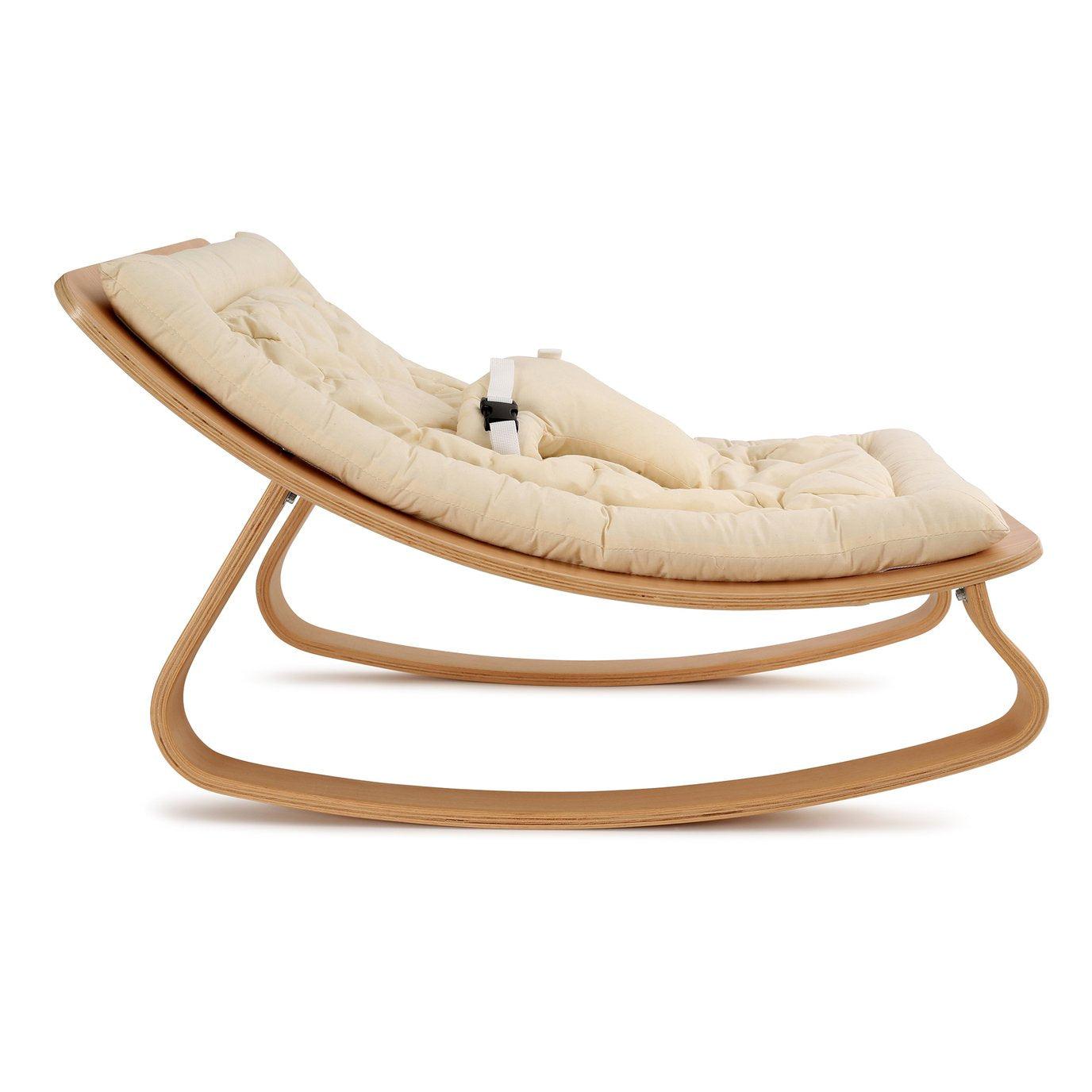 A Levo Rocker by Charlie Crane with a wooden baby rocker and an Organic White cover.