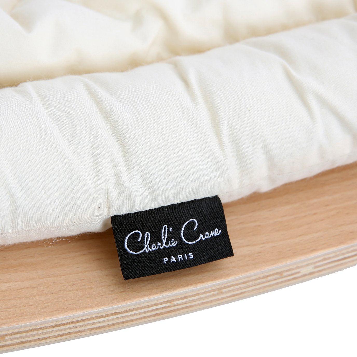 A Levo Rocker with a label on an Organic White pillow by Charlie Crane.