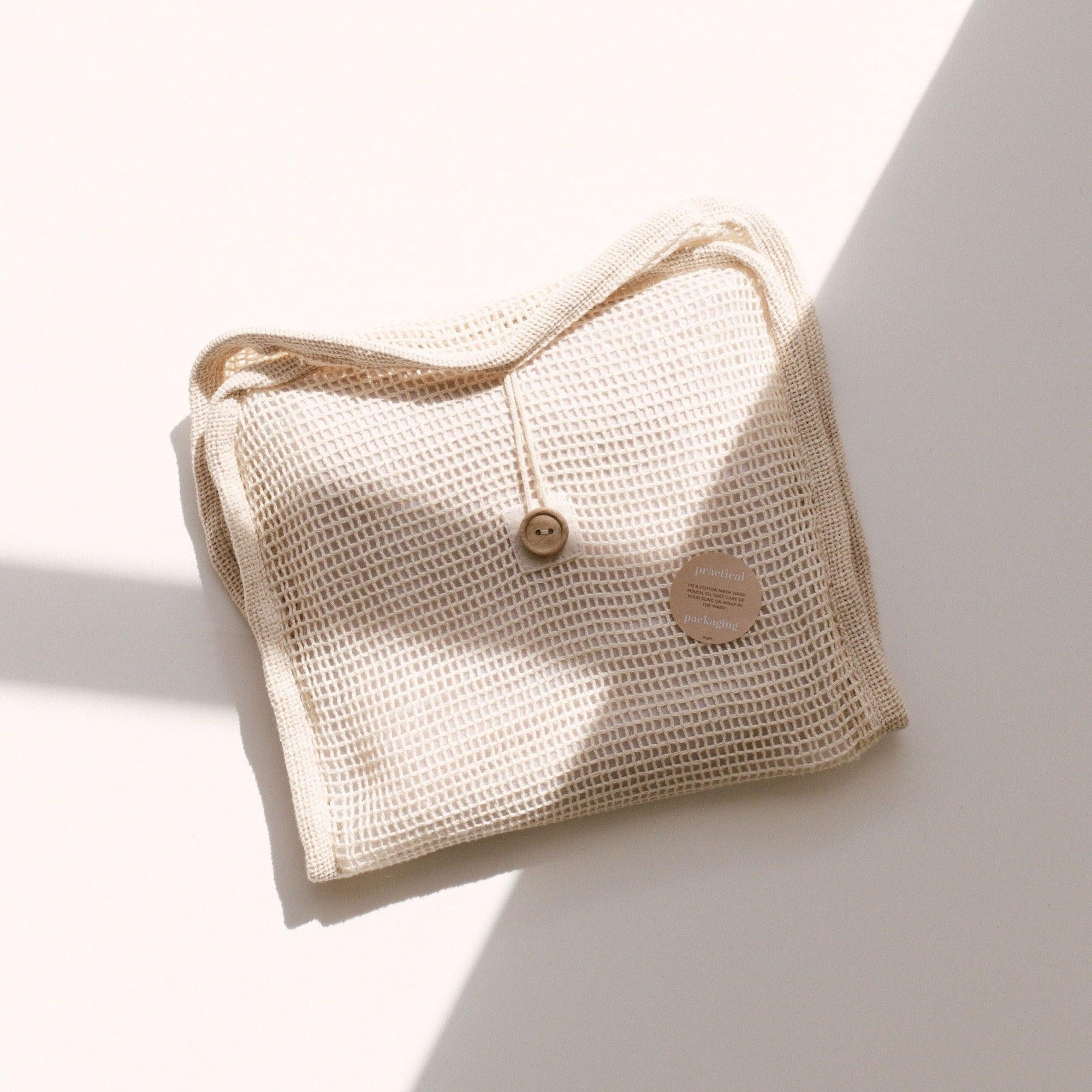 A beige bag by Chekoh on a white surface.