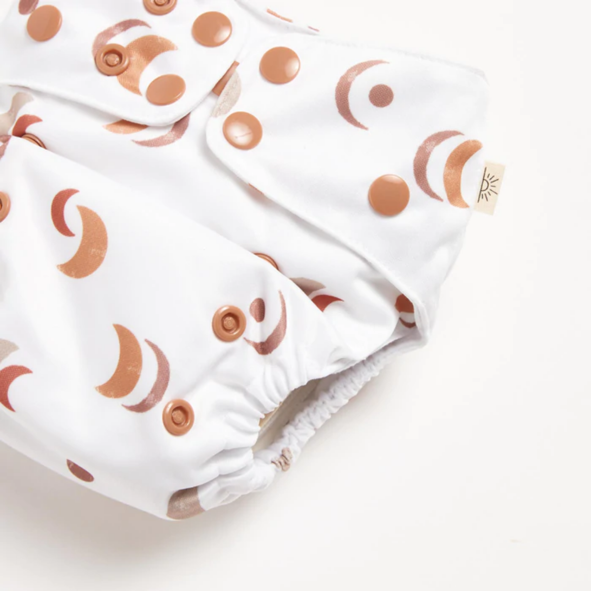 A close up of EcoNaps Desert Moon 2.0 Modern Cloth Nappy on a white surface.