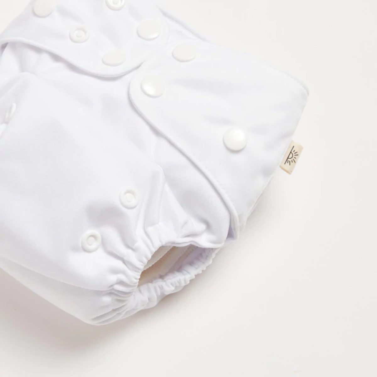 A Snow White 2.0 Modern Cloth Nappy by EcoNaps on a white surface.
