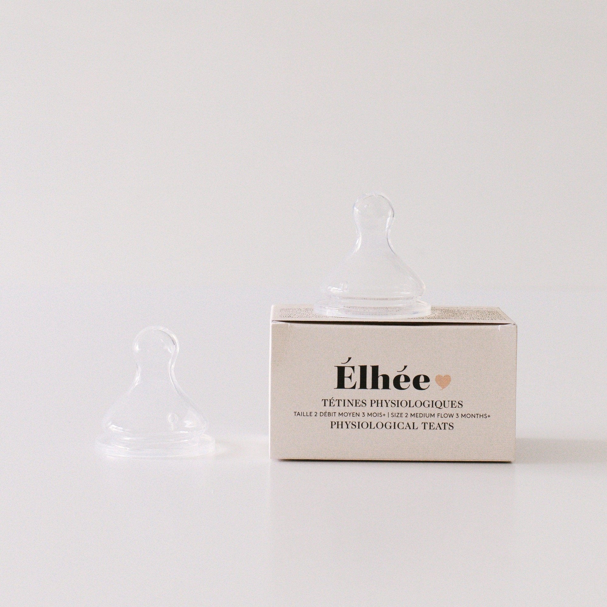 A set of Elhée France medium flow teats sitting on and next to their box on a white surface.