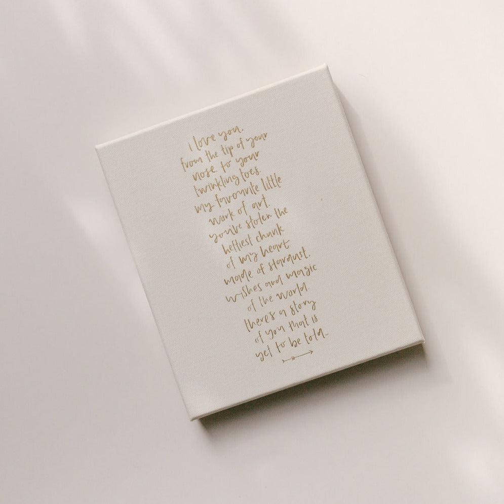 The back of the Emma Kate Co. Little Dreamer Baby Journal in cloud featuring a quote in gold lettering.