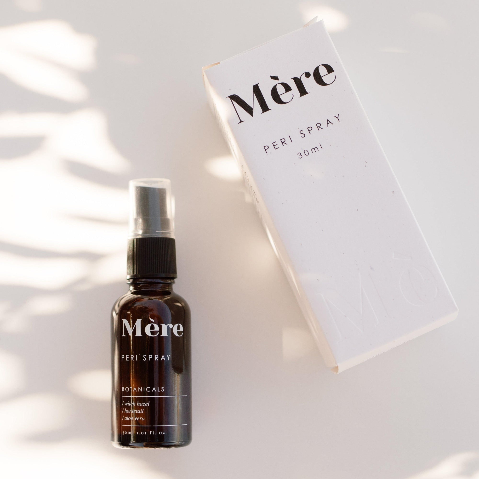 An image of Mere Healing Peri Spray next to the box.