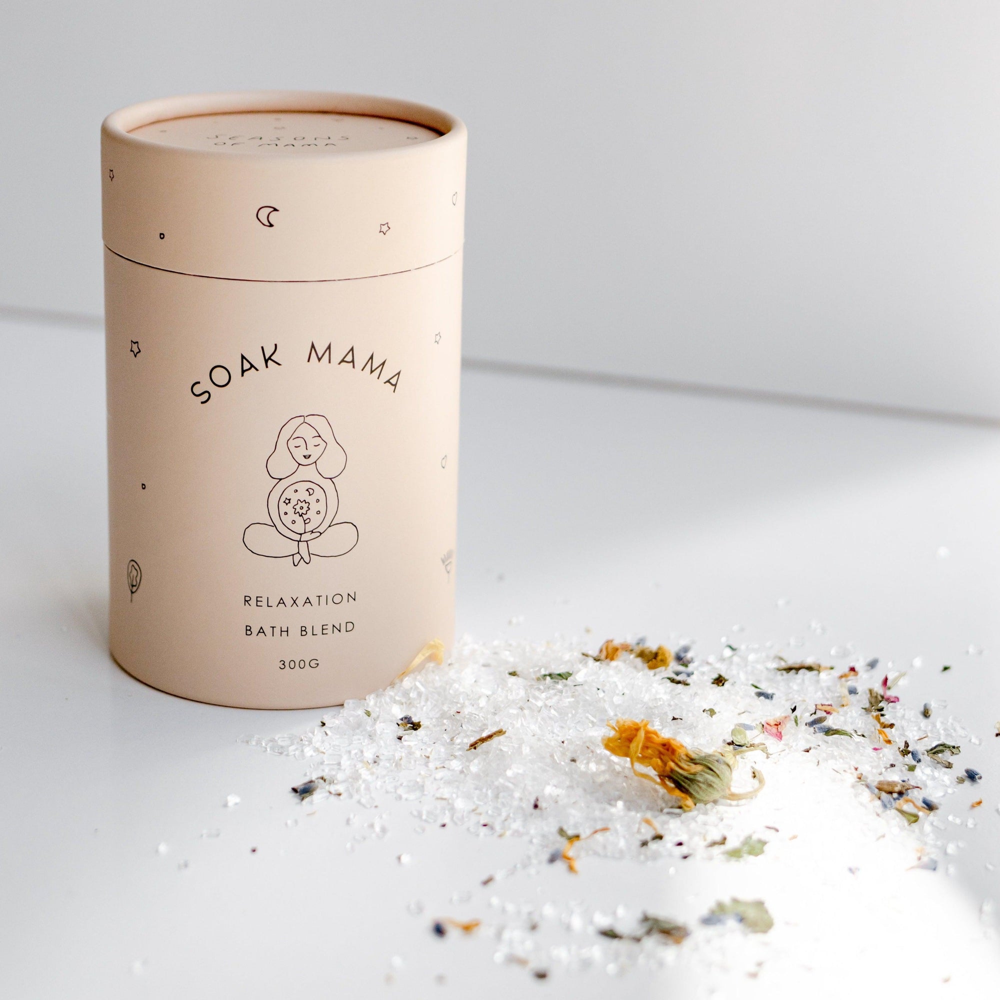 A tin of Seasons of Mama's Soak Mama Relaxation bath blend sitting on a table.