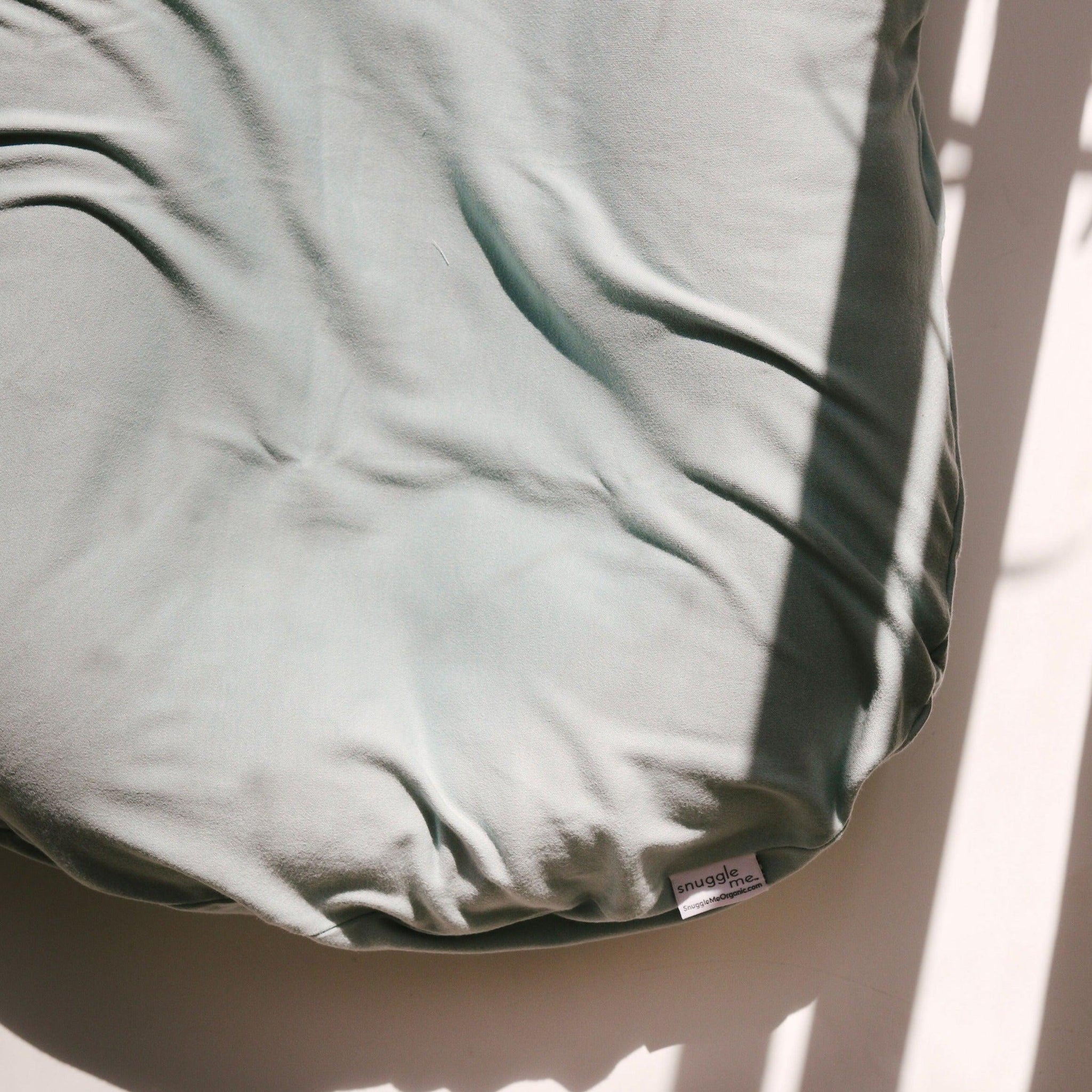 A close up image of The Snuggle Me® Lounger in a green shade.