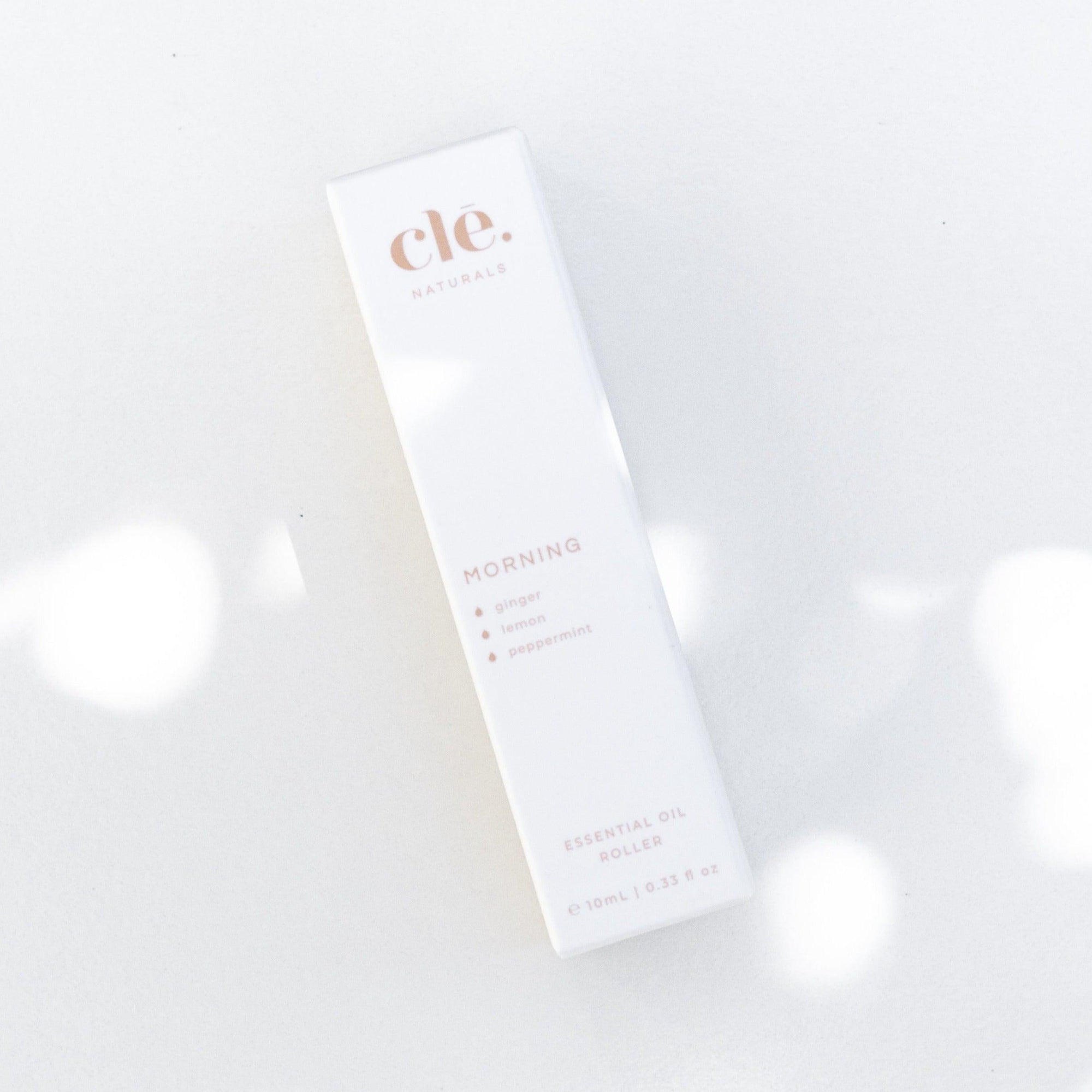 A box of of Clē Naturals morning essential oil on a white surface.