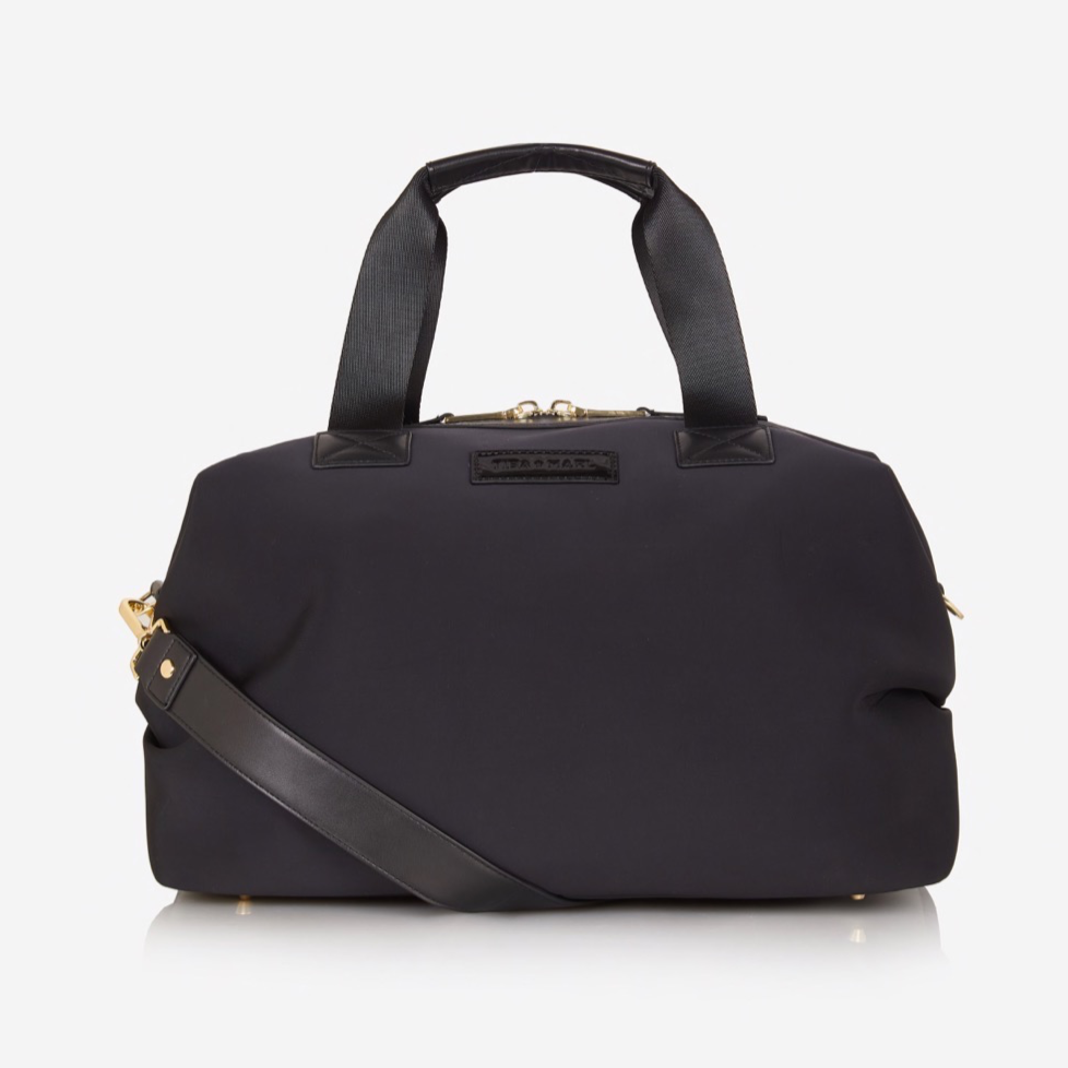 A sleek and compact every-day version of our best selling RAF WEEKENDER. Smaller but perfectly formed and includes all original internal functionality.   This hard-working holdall gets a sports-lux make-over in sleek Black scuba fabric, paired with lux gold hardware. The perfect size to fit all your essential items for a day out, it also doubles up as a stylish work bag, hand bag or overnight bag.