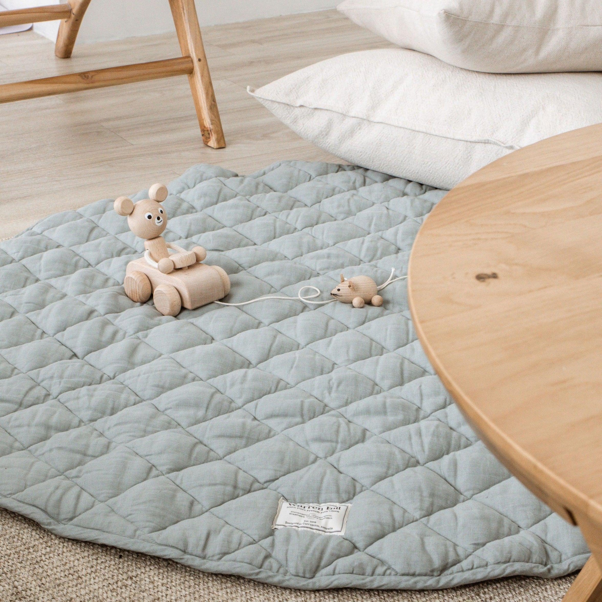 Our Warren Hill 'Aqua' baby play mat is made from 100% Pure French Flax Linen with a soft, polyester filling that provides cushion and support for your child's delicate skin. Our linen is stonewashed giving it that beautiful soft, worn-in feel from the first time your child plays on it. Linen is naturally hypoallergenic, extremely durable, and one of the most sustainable materials to harvest and produce in the textile industry.