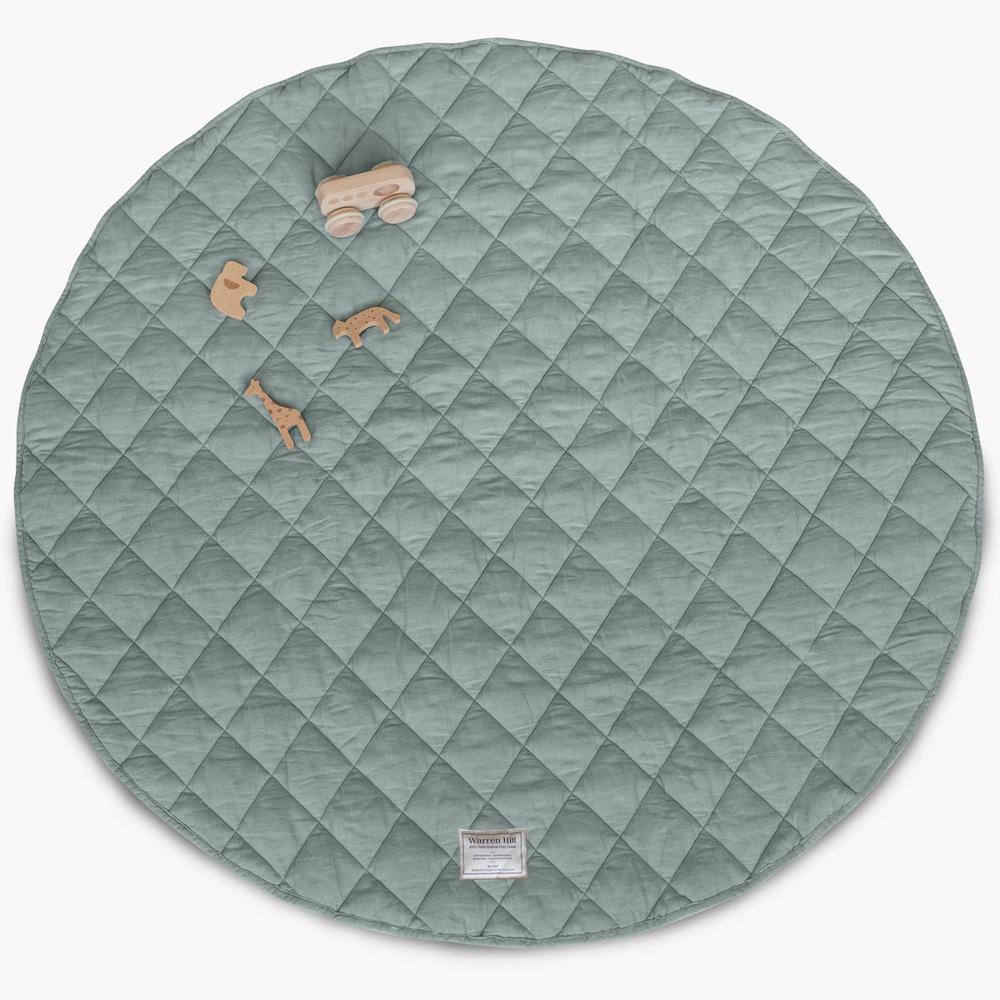 Our Warren Hill 'Aqua' baby play mat is made from 100% Pure French Flax Linen with a soft, polyester filling that provides cushion and support for your child's delicate skin. Our linen is stonewashed giving it that beautiful soft, worn-in feel from the first time your child plays on it. Linen is naturally hypoallergenic, extremely durable, and one of the most sustainable materials to harvest and produce in the textile industry.